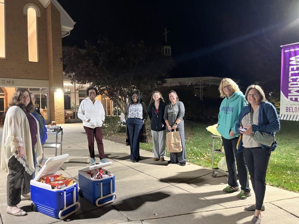 photo of women distributing free dinners to families