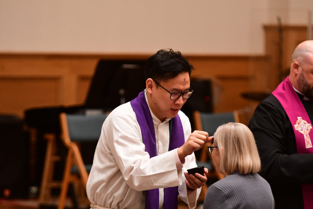 Pastor Minoo administering ashes