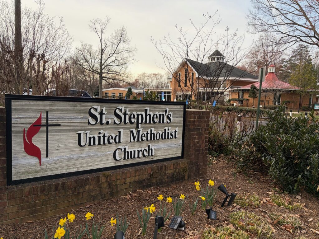 Church sign and daffodils