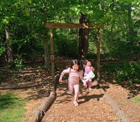Two girls running out of urban forest