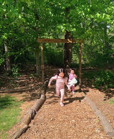 Two girls running out of urban forest