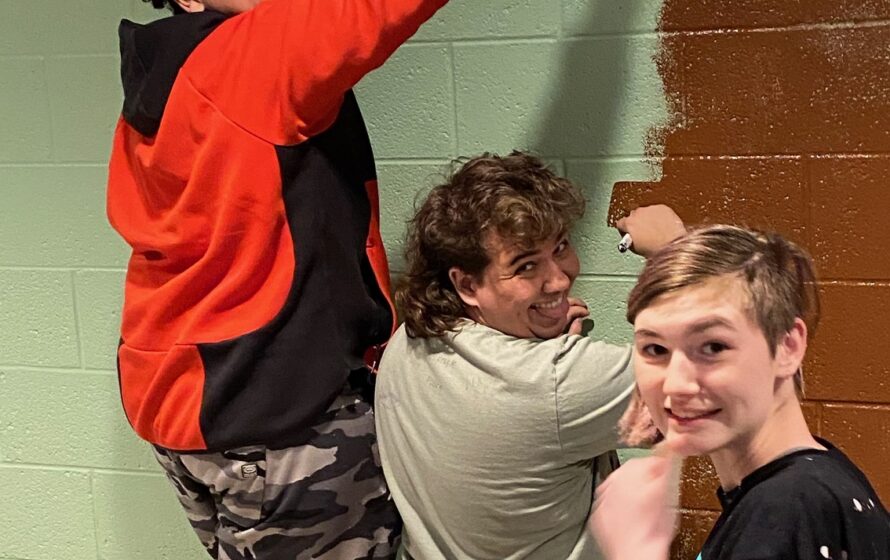 Youth group members painting a mural