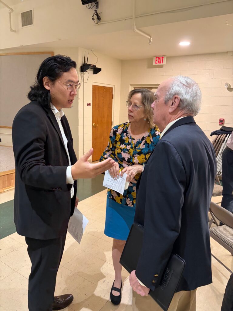 Pastor Minoo talking to people