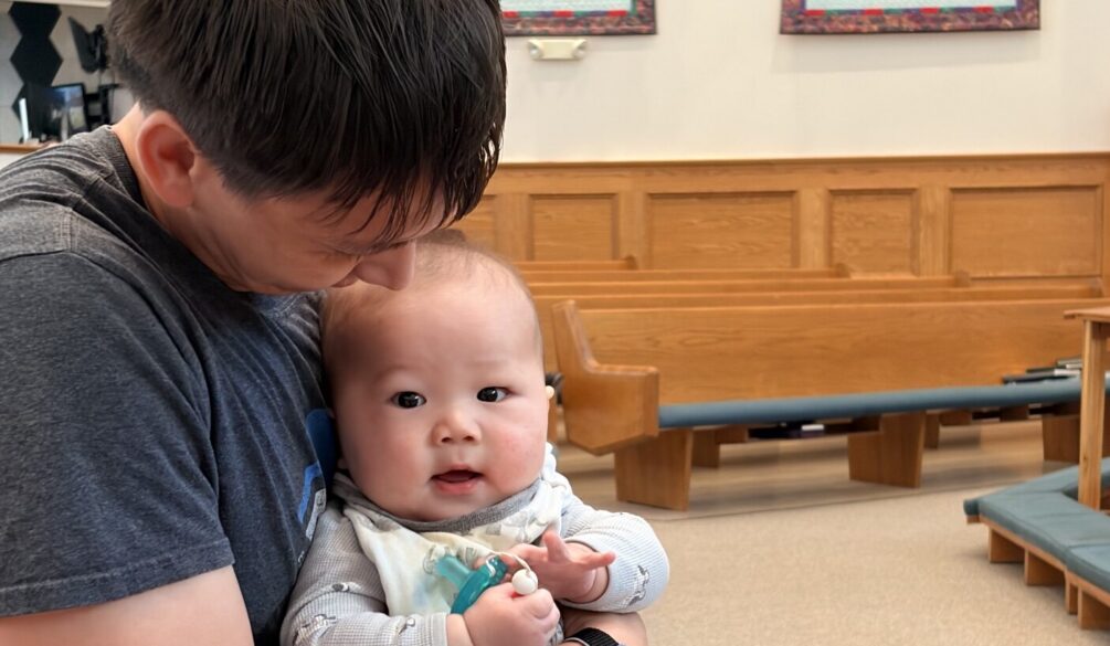 Father and baby in pew