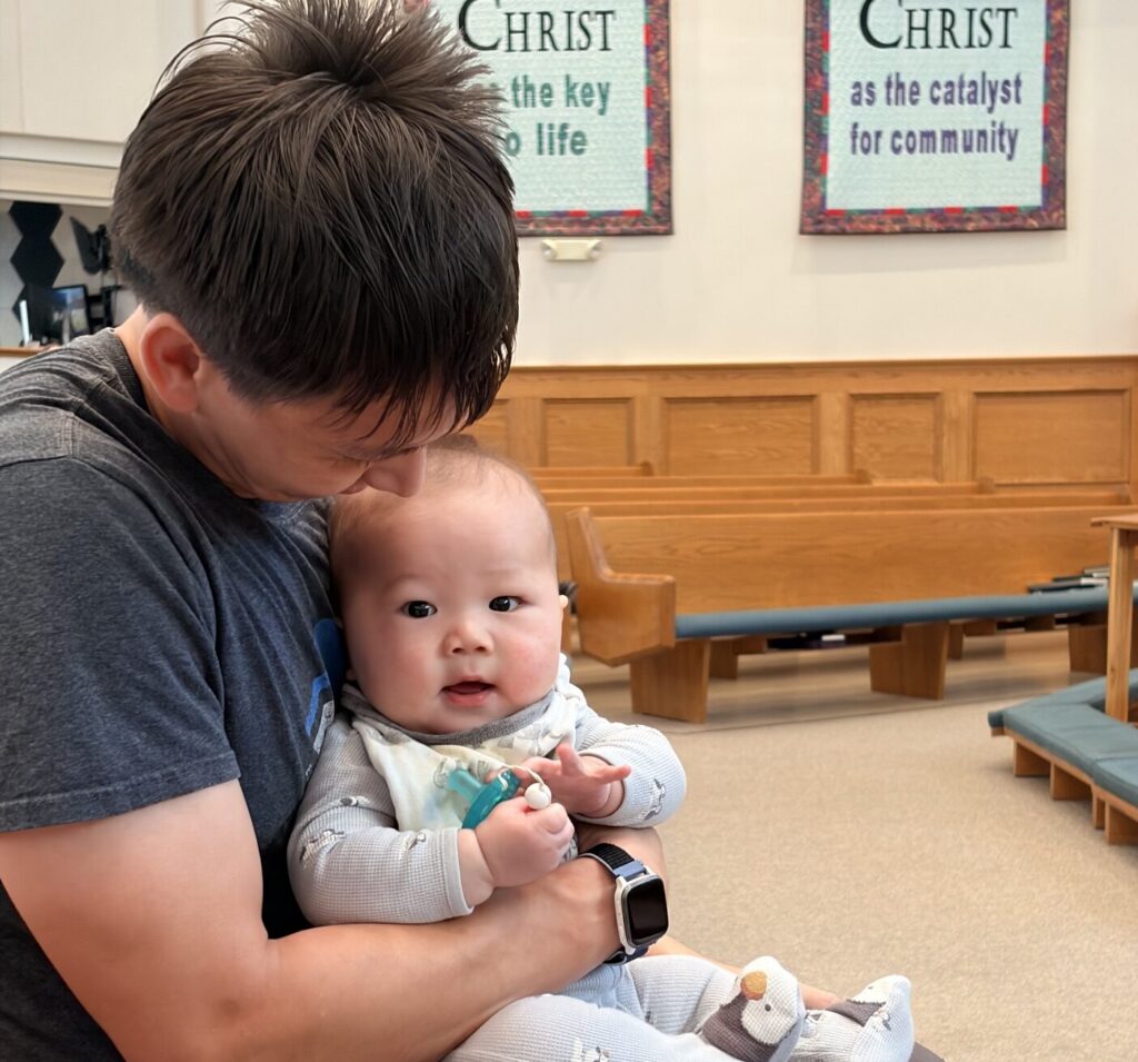 Father and baby in pew