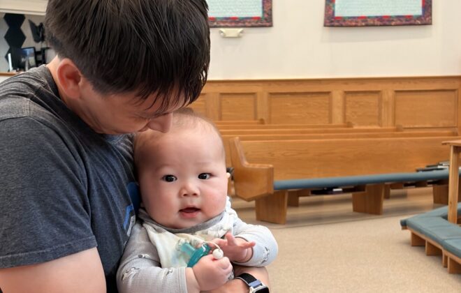 Father and baby in pew