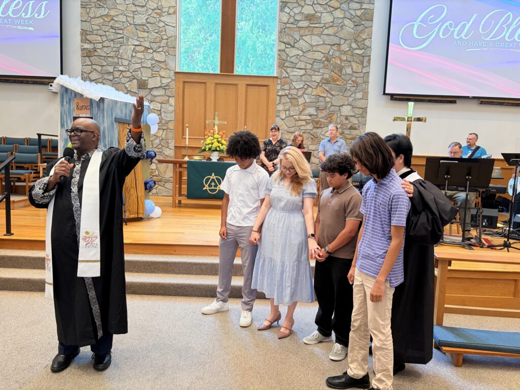 Pastors blessing those going on Youth Mission trip