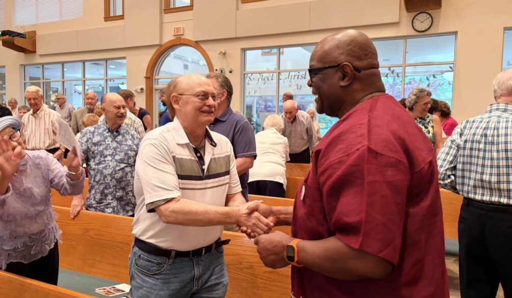Pastor Chaney greeting parishoners
