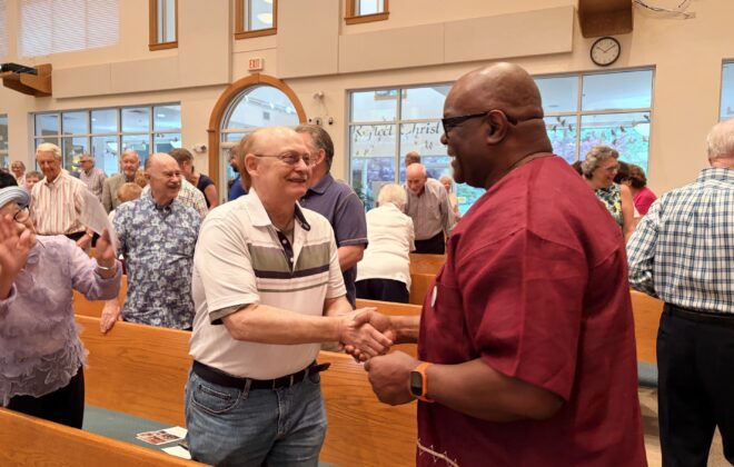 Pastor Chaney greeting parishoners