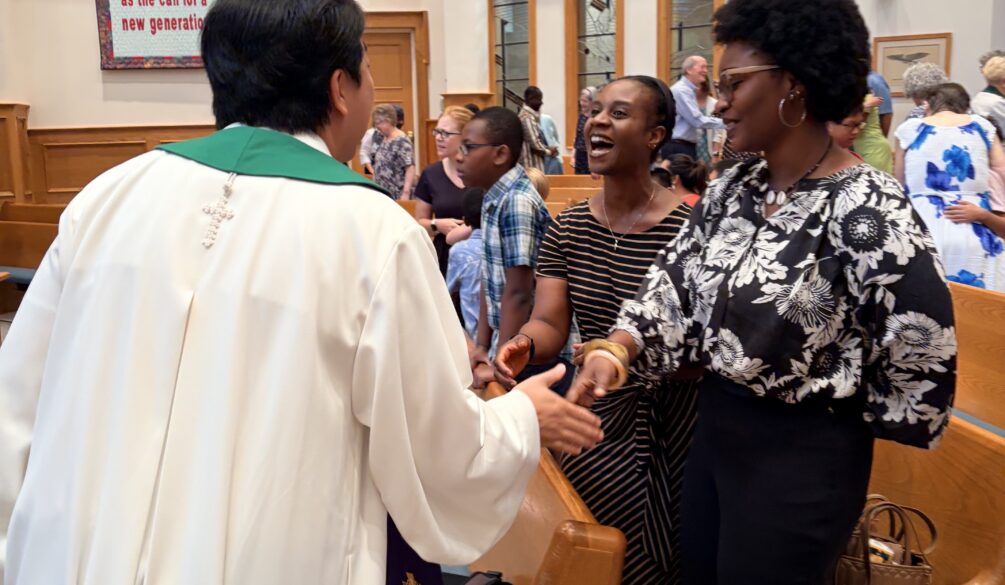 Pastor Sunu during passing of the peace