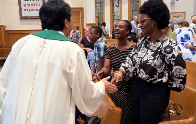 Pastor Sunu during passing of the peace