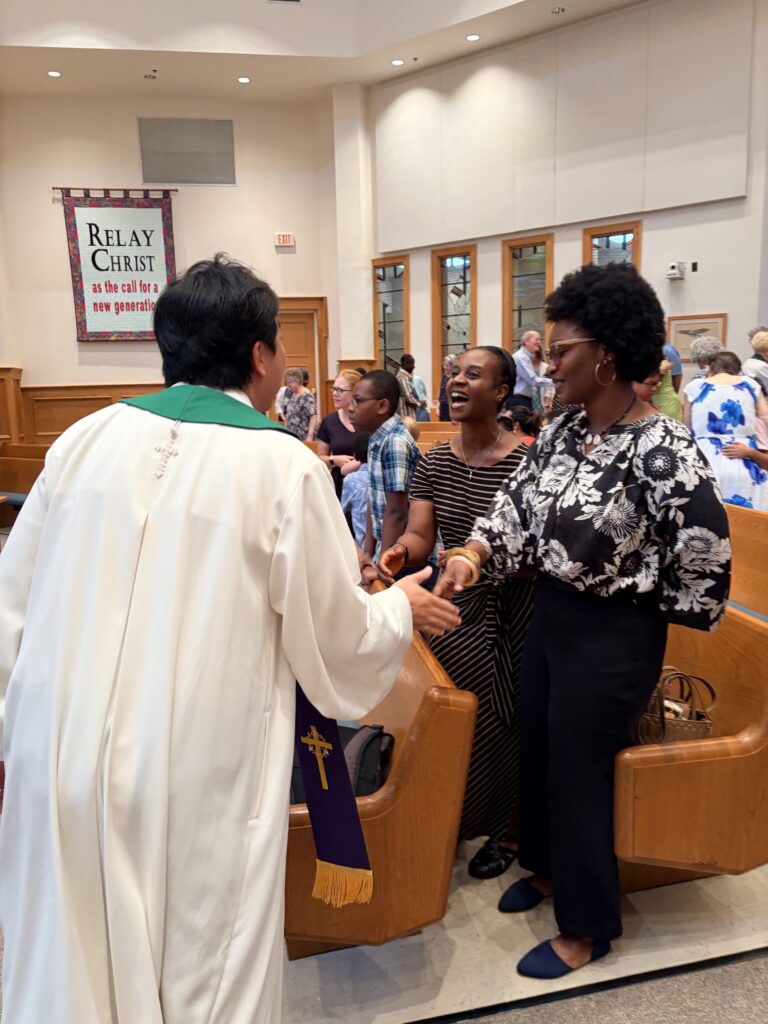 Pastor Sunu during passing of the peace