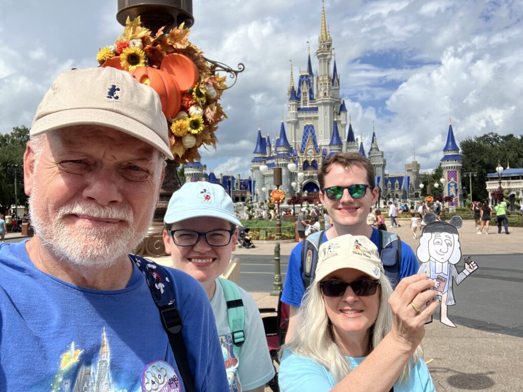 Family at Disney holding a flat John Wesley