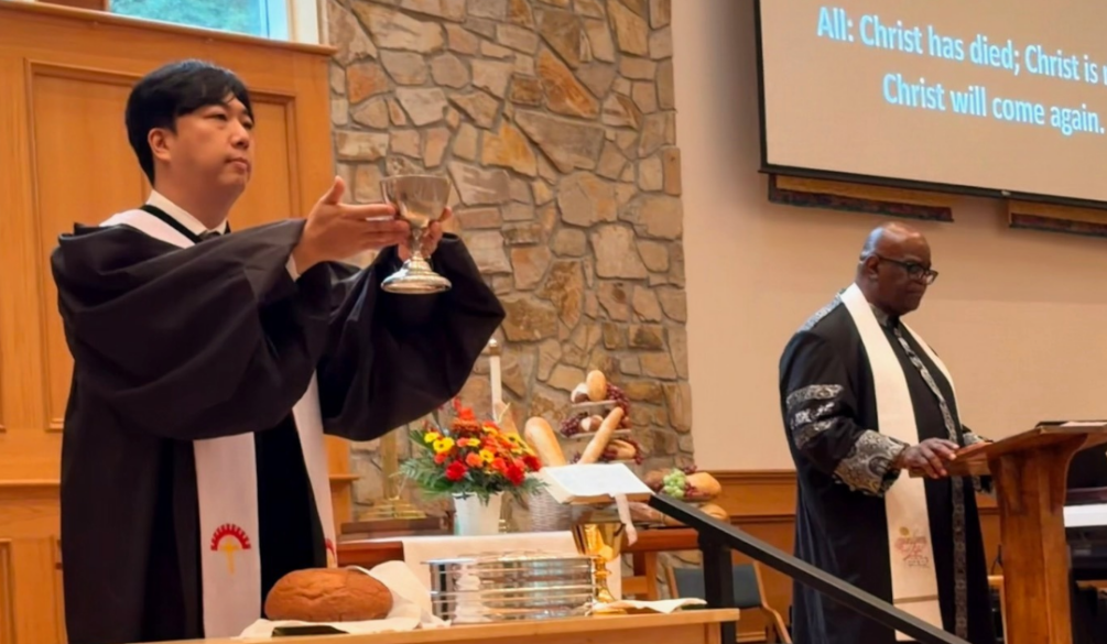Pastor Sunu at the communion table
