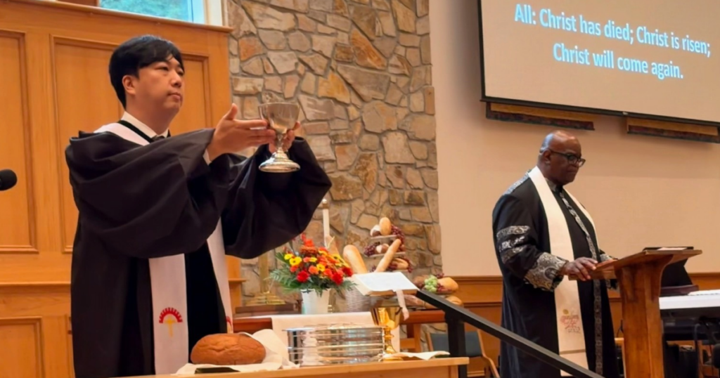 Pastor Sunu at the communion table
