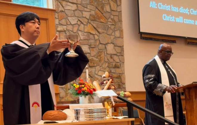 Pastor Sunu at the communion table